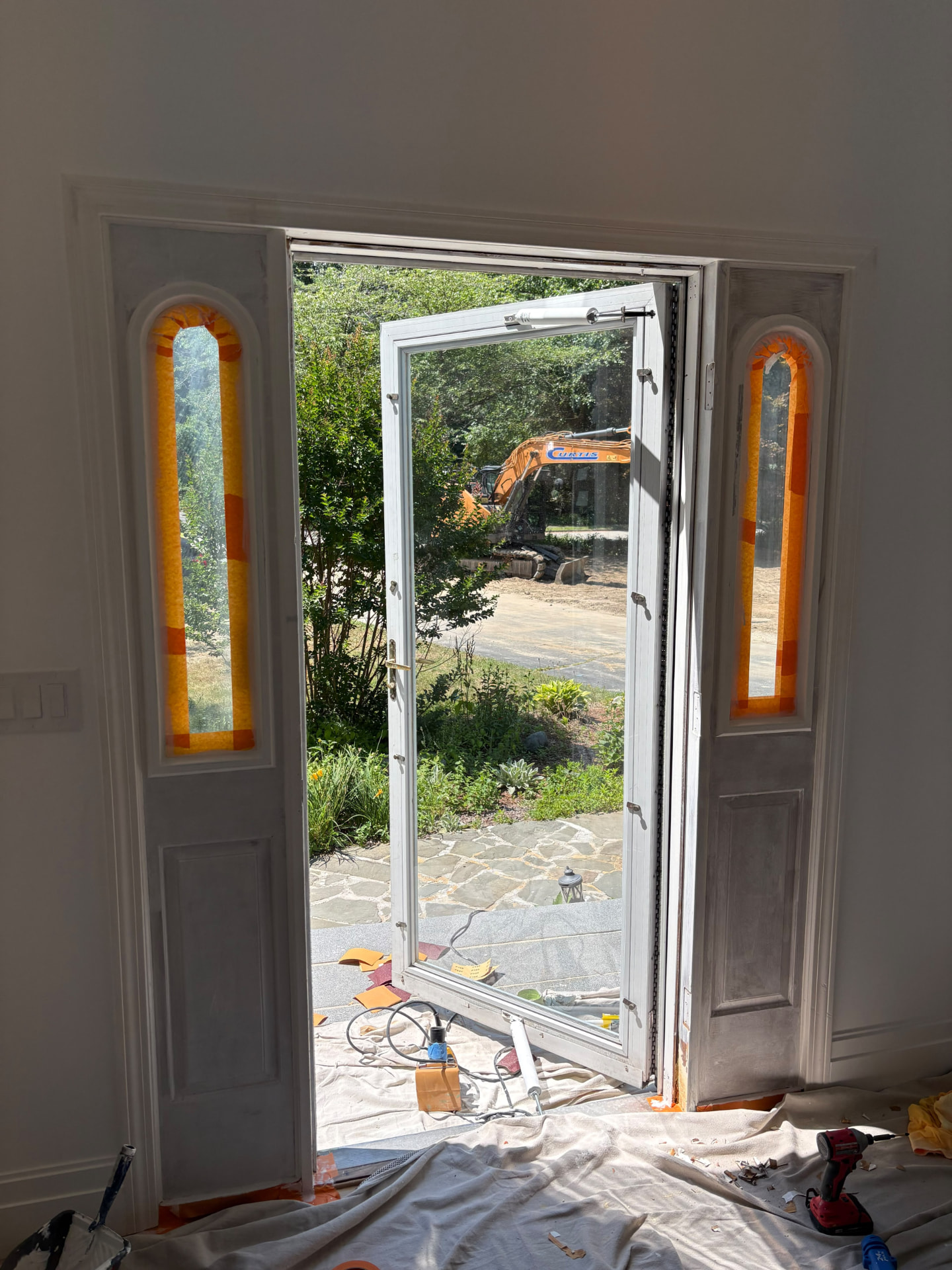Front entry masked and prepared for painting with protective coverings in place