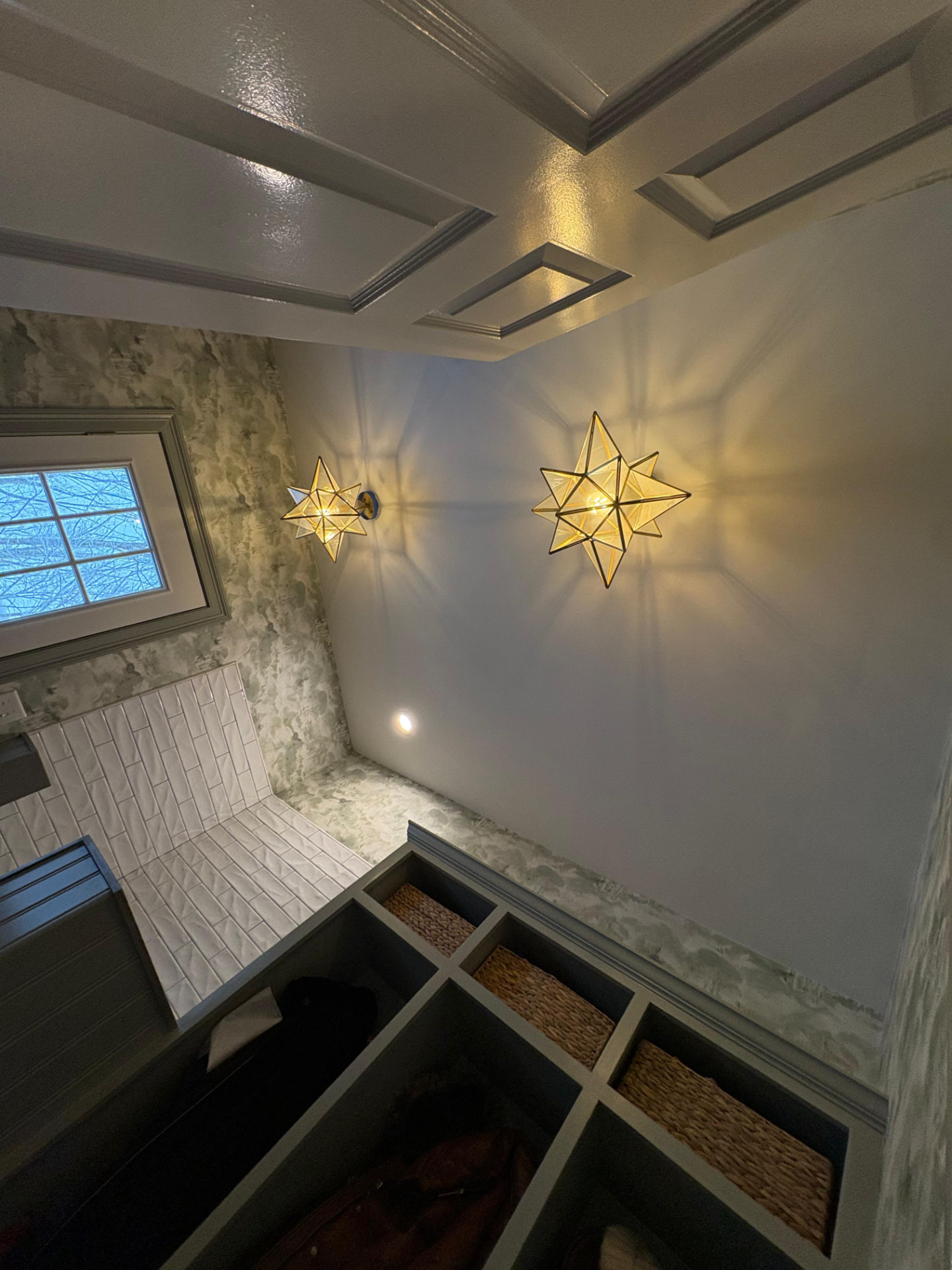 Freshly painted mudroom with coffered ceiling, star sconces and custom built-in cubbies